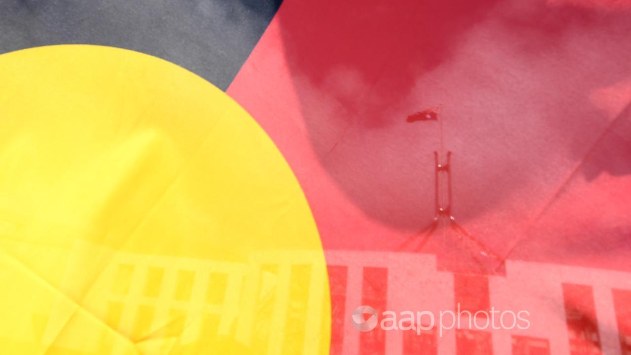 Parliament House is seen through an Aboriginal flag (file image)