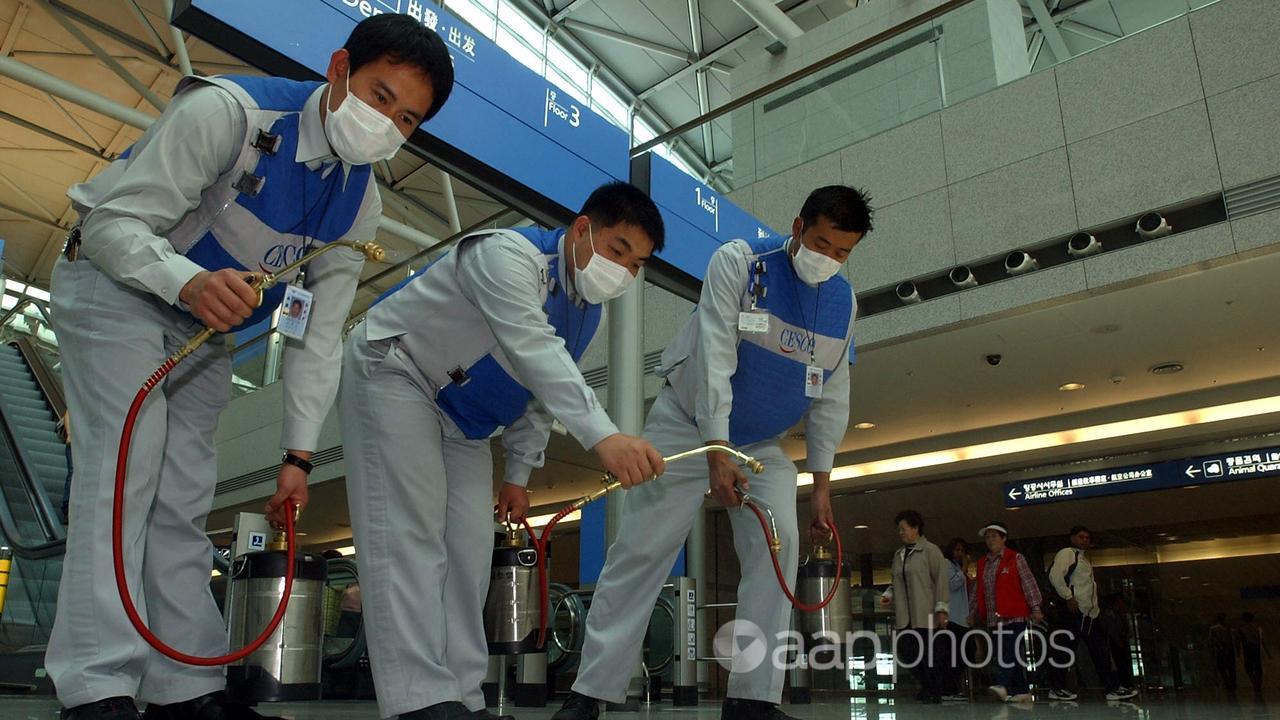 Workers disinfect a South Korean airport (file image)