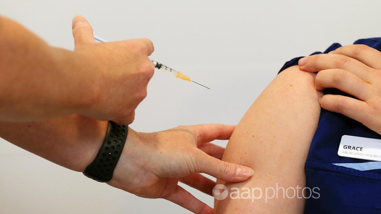 A nurse receives a COVID-19 vaccine (file image)