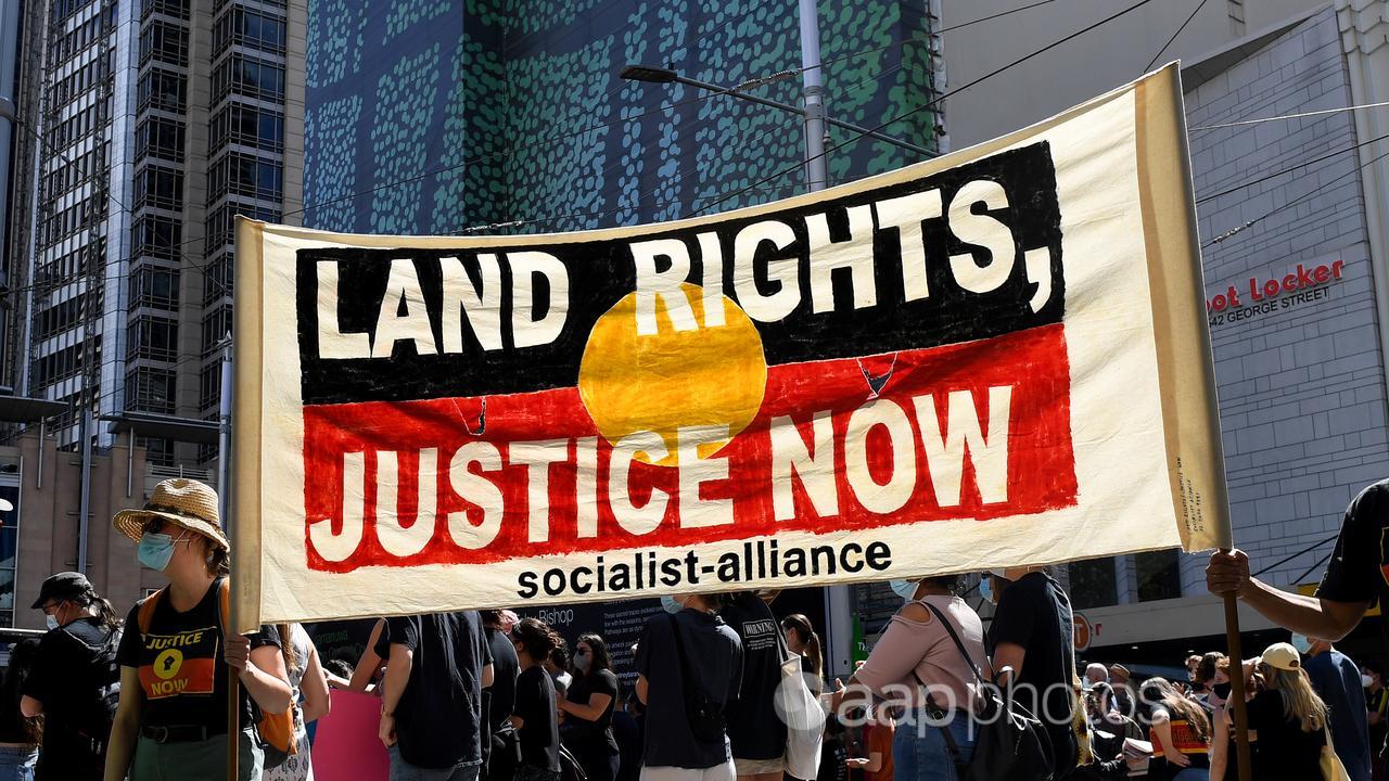 Protesters hold a land rights placard (file image)