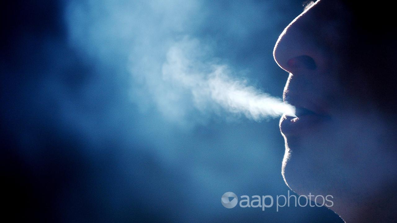 A person exhales smoke from a cigarette (file image)