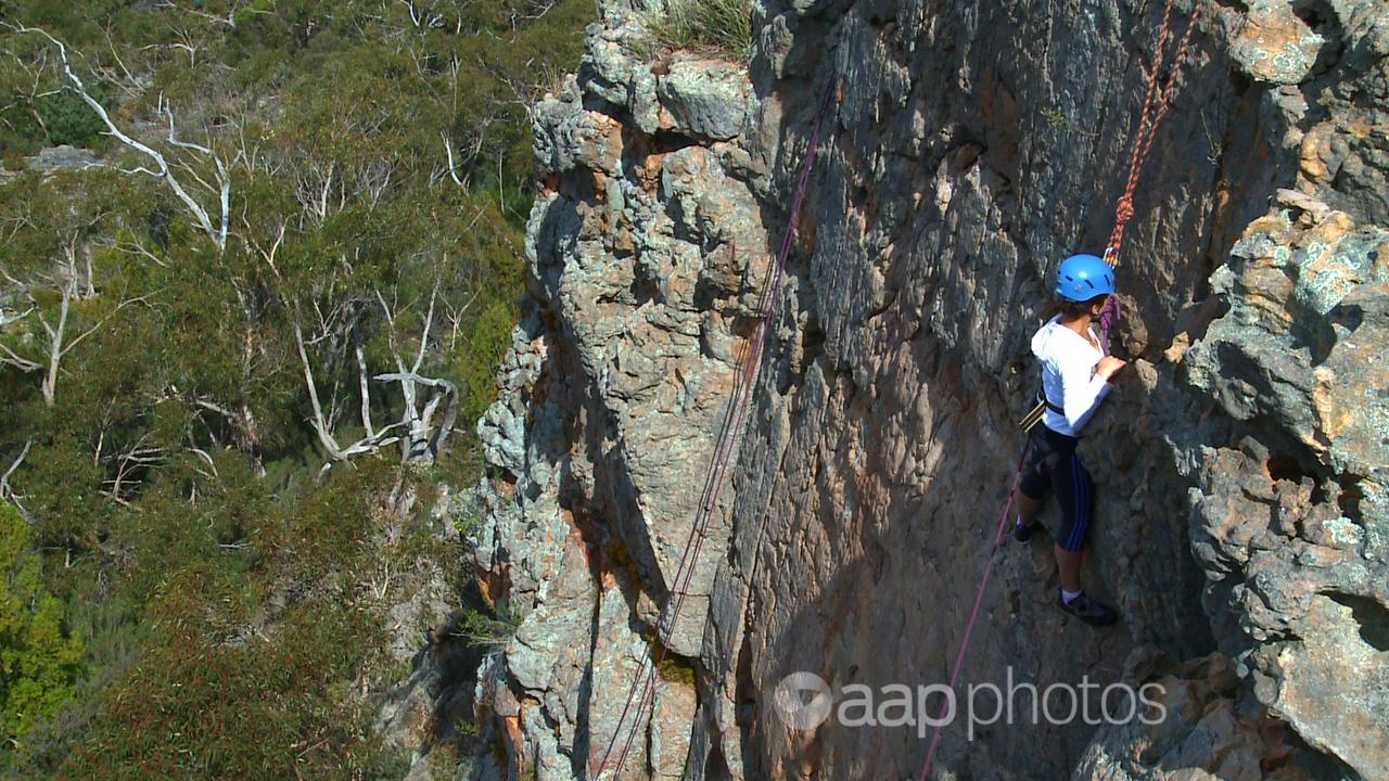 A climber scales a rock in Victoria's Grampians region