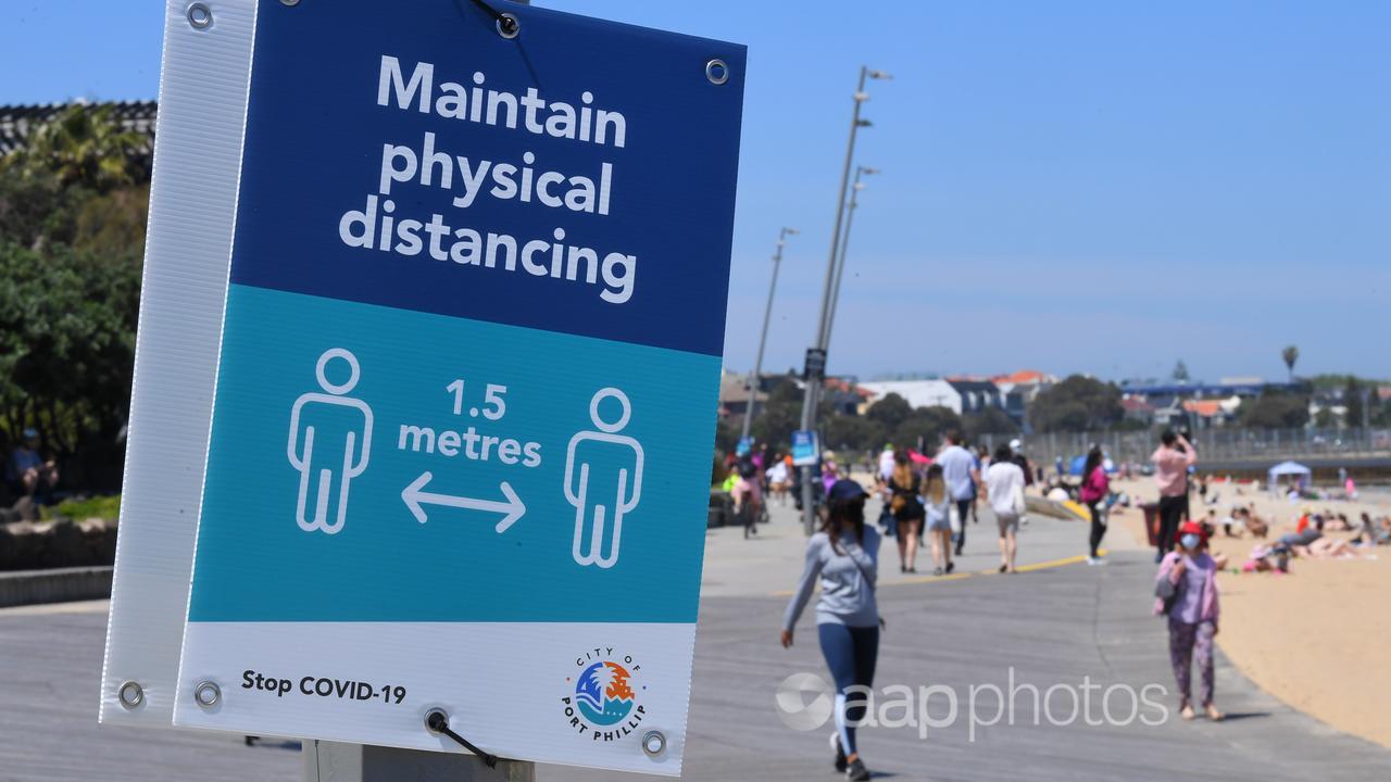 Social distancing signage along St Kilda beach in Melbourne