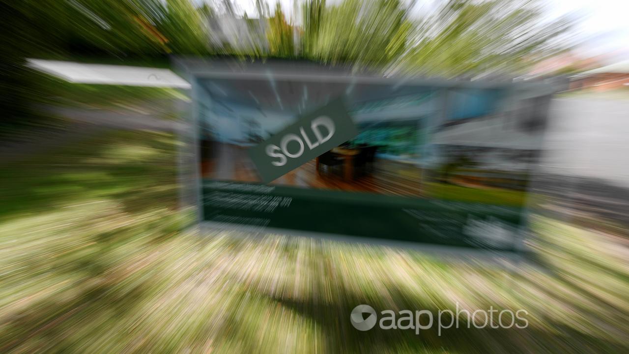 A real estate advertising board with a Sold sign (file image)