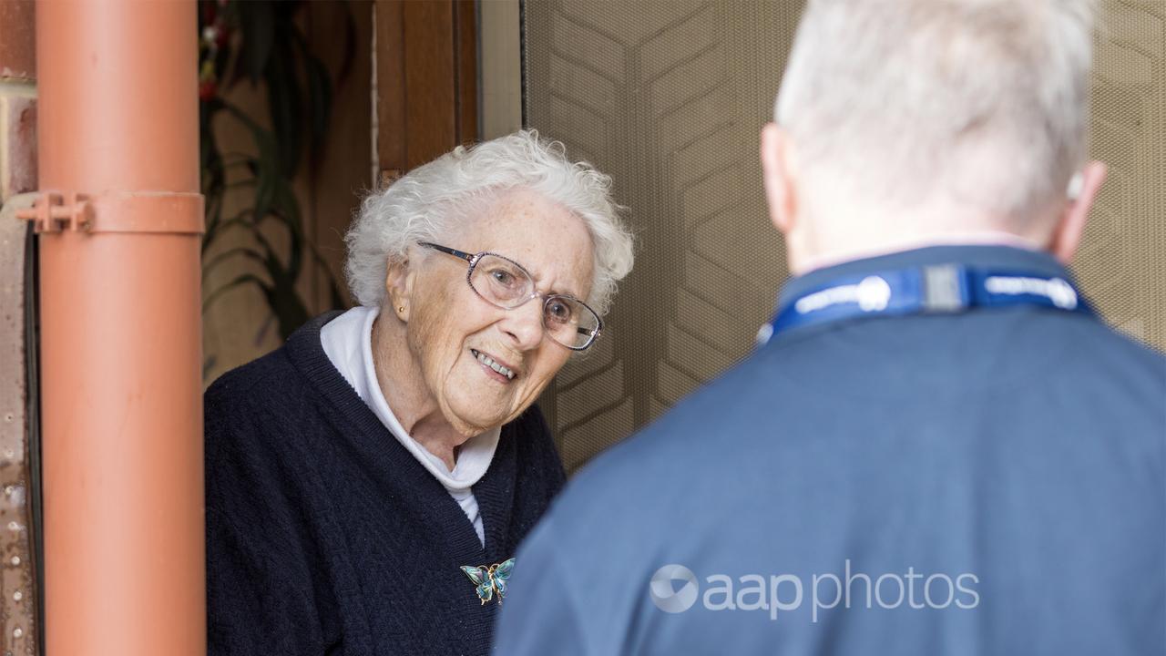 A Meals on Wheels customer receives a visiting volunteer.