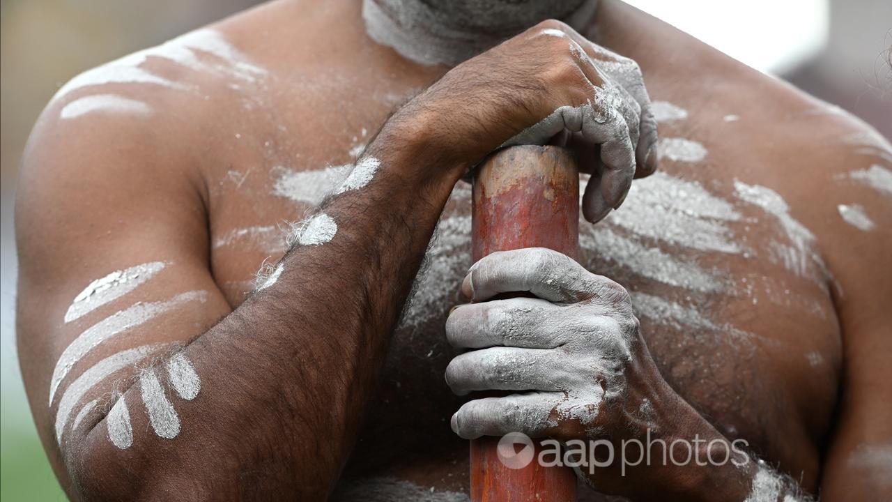 An Indigenous man holding a didgeridoo (file image)