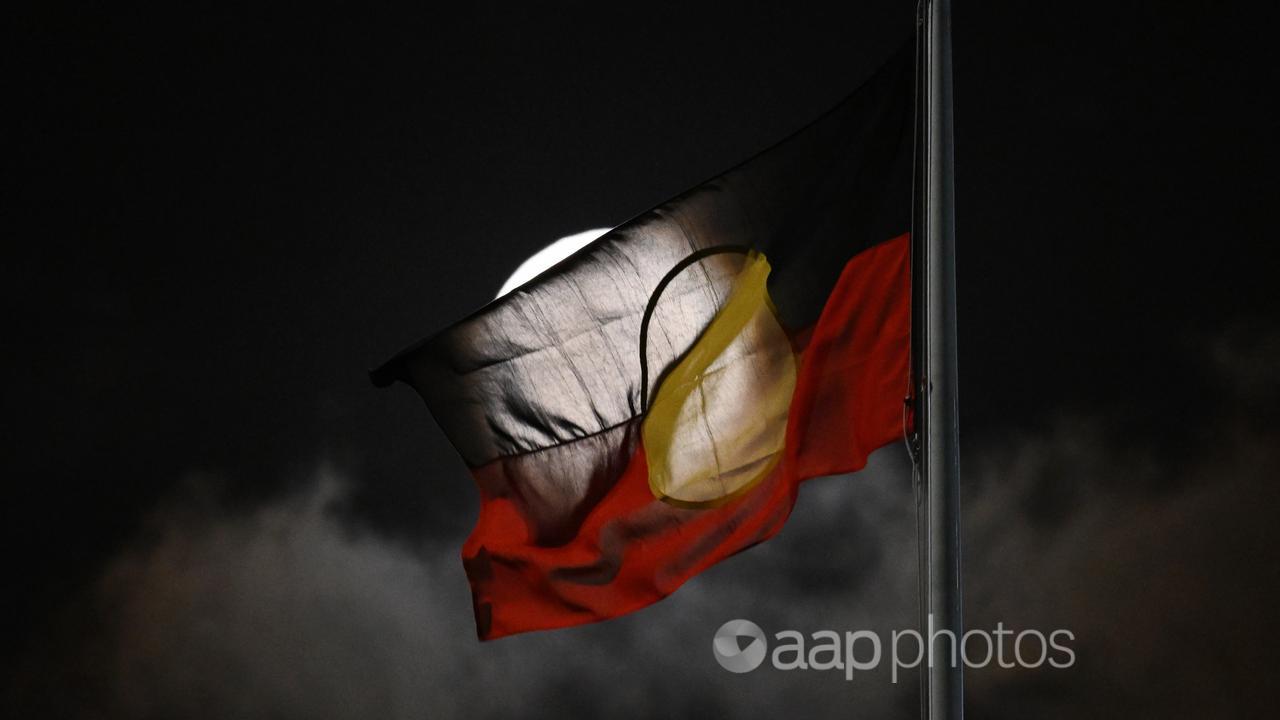 A supermoon is seen with the Aboriginal flag in Sydney (file image)