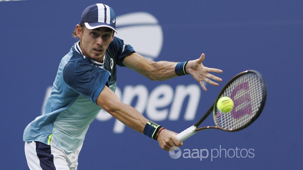 Alex de Minaur returns against Daniil Medvedev at the US Open.