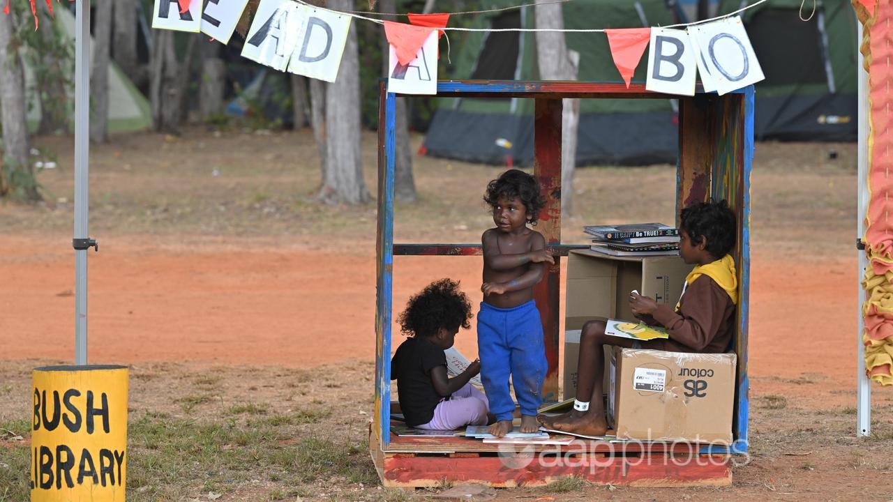 Aboriginal children read books at a bush library (file image)