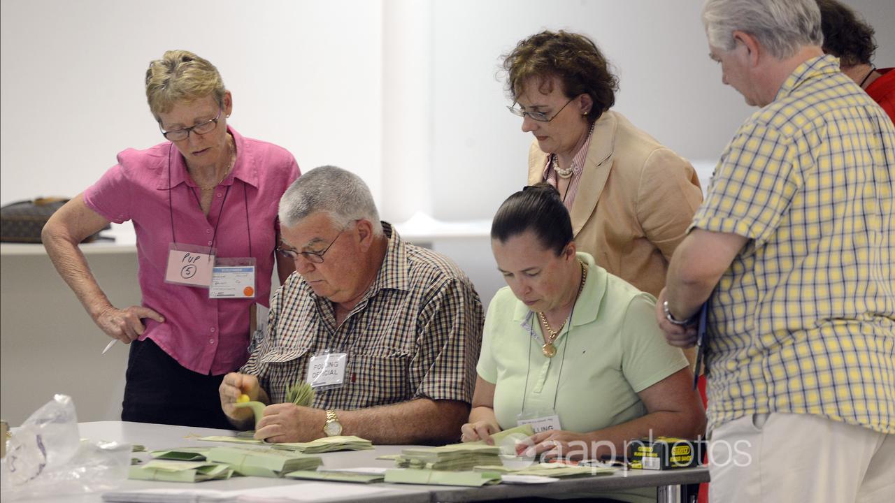 Scrutineers watch over election officials (file image)