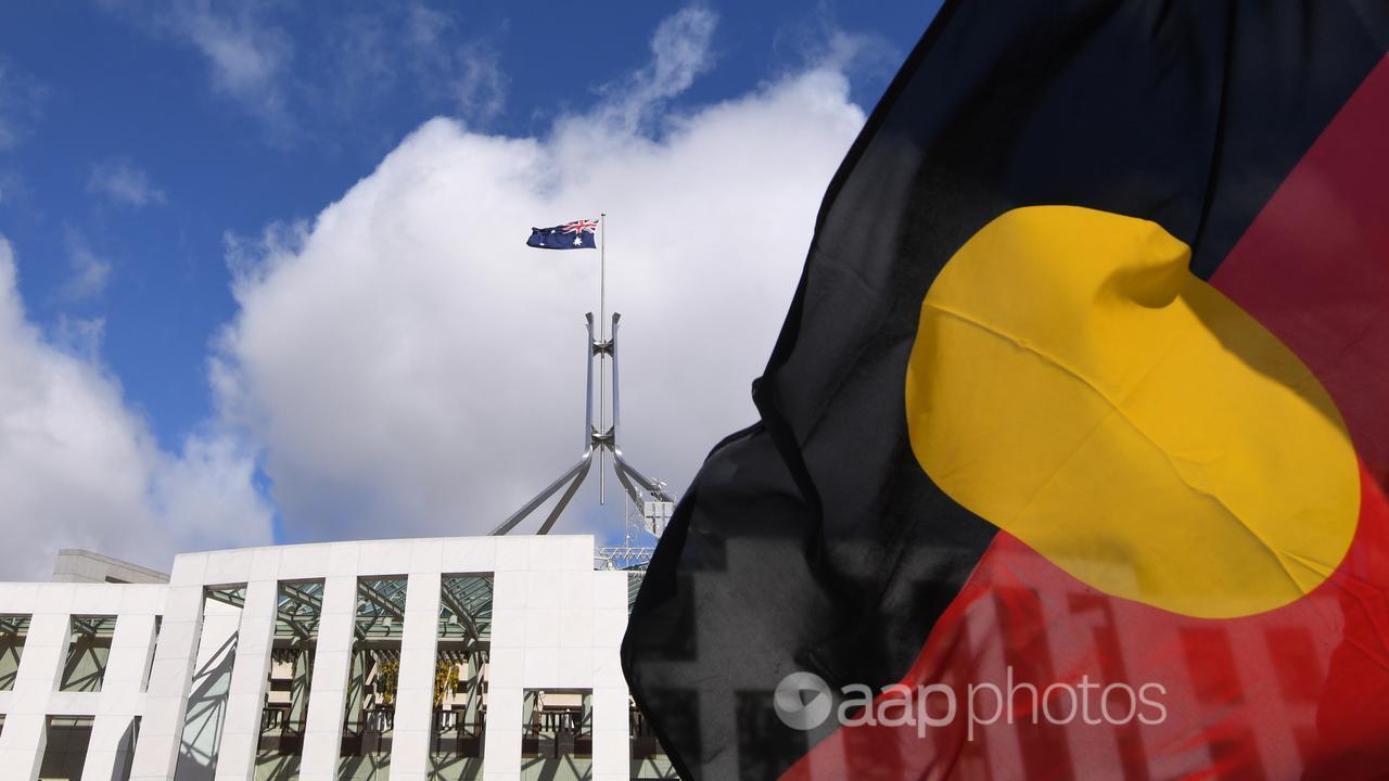 Parliament House seen through an Aboriginal flag (file image)
