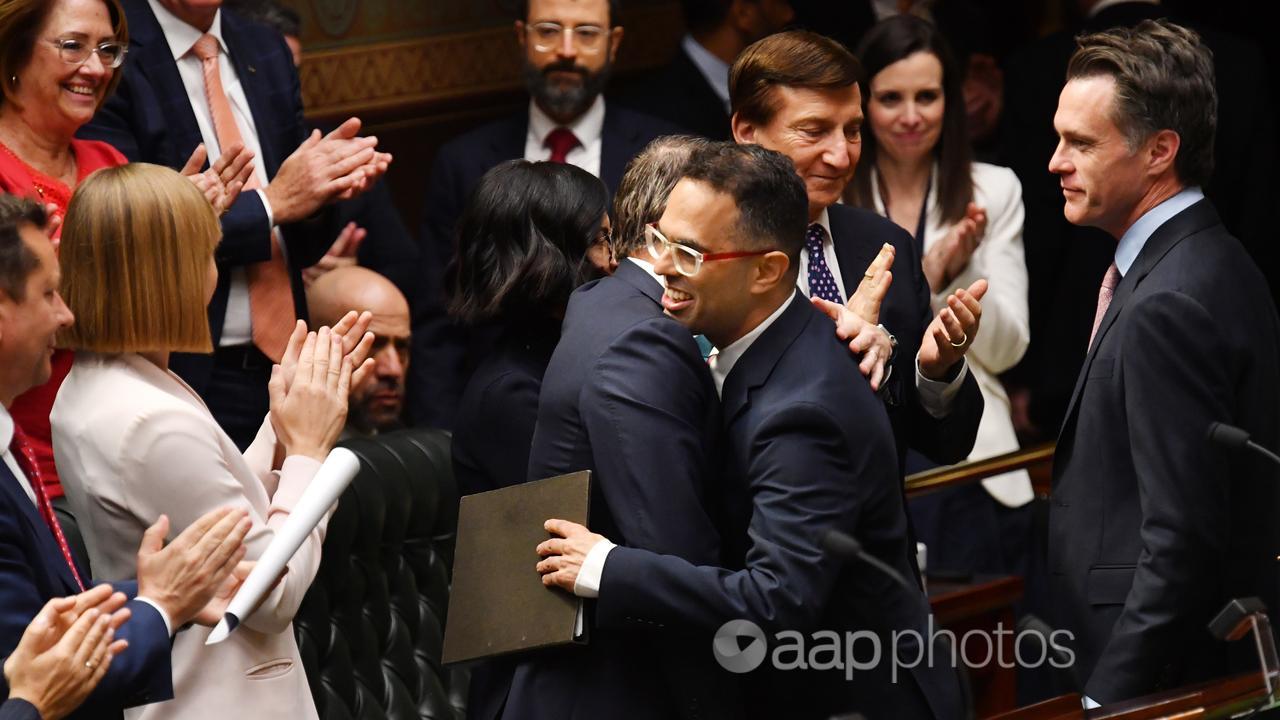 NSW Treasurer Daniel Mookhey is embraced by his Labor colleagues