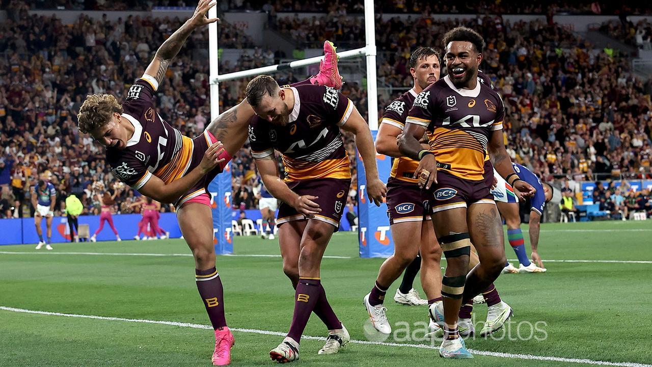 Broncos players celebrate a prelim final try against the Warriors.