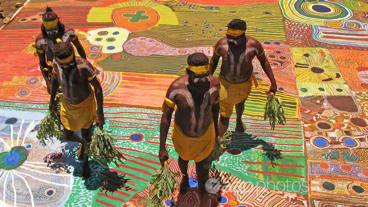 Indigenous dancers with a dot painting canvas (file image)