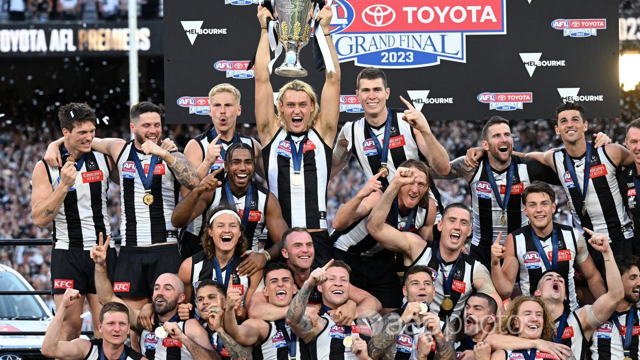 Collingwood players celebrate their 2023 AFL grand final win.