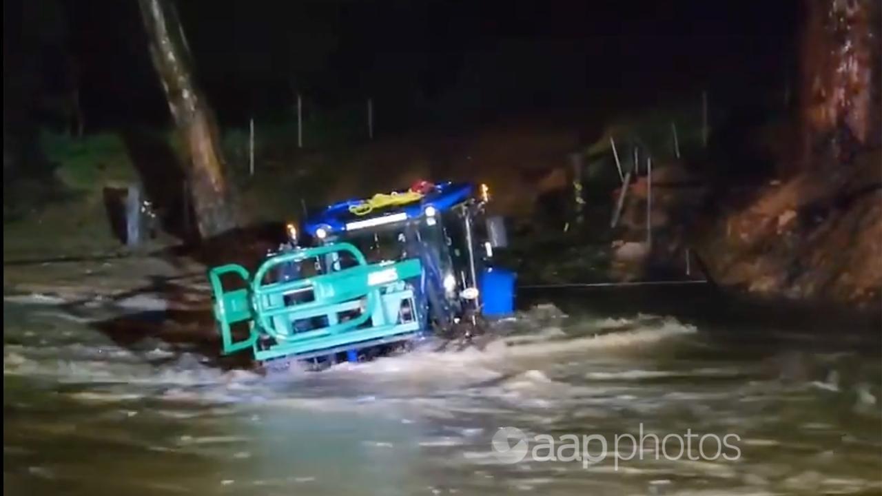 A farmer's tractor stranded in floodwaters