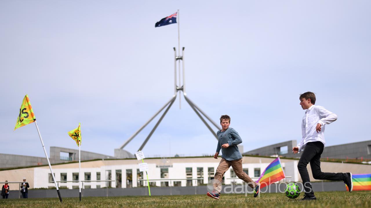 Kids playing soccer in front of Parliament House (file image)