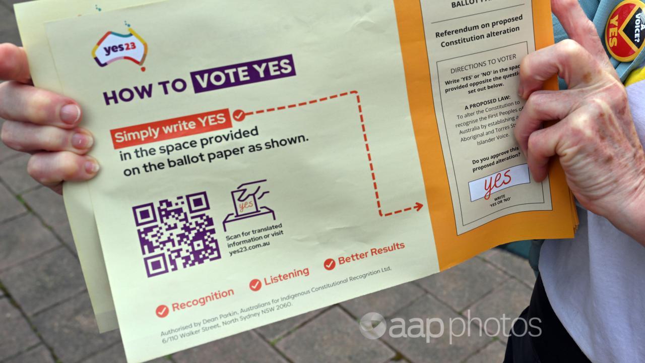 A volunteer holds a Yes pamphlet (file image)