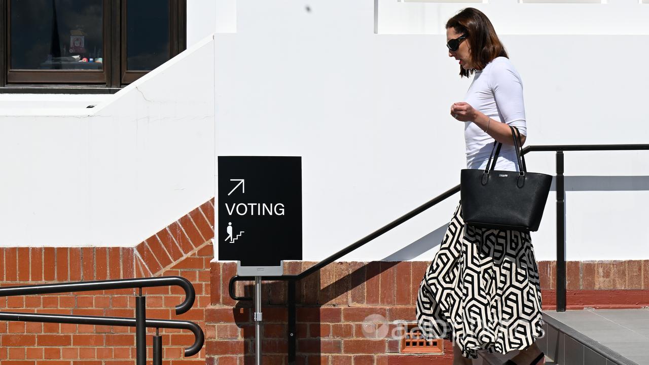 A woman leaves after casting her vote