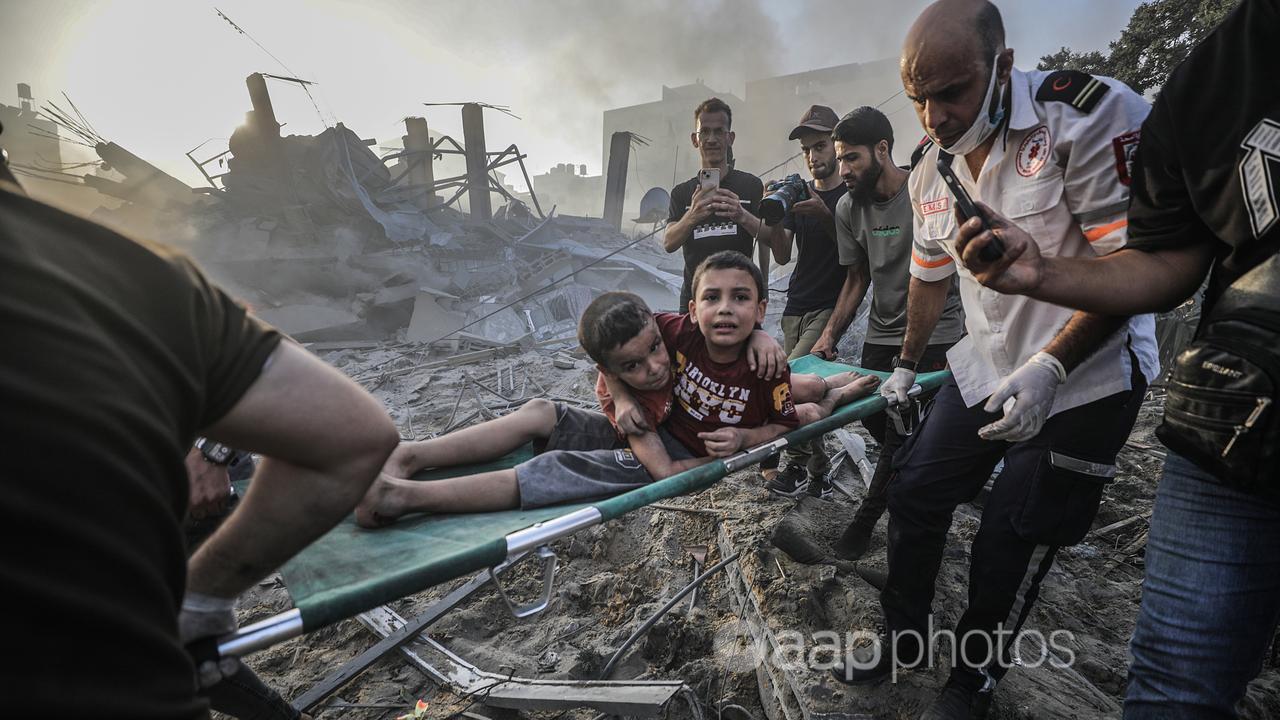Injured brothers are helped to safety in the Gaza Strip.