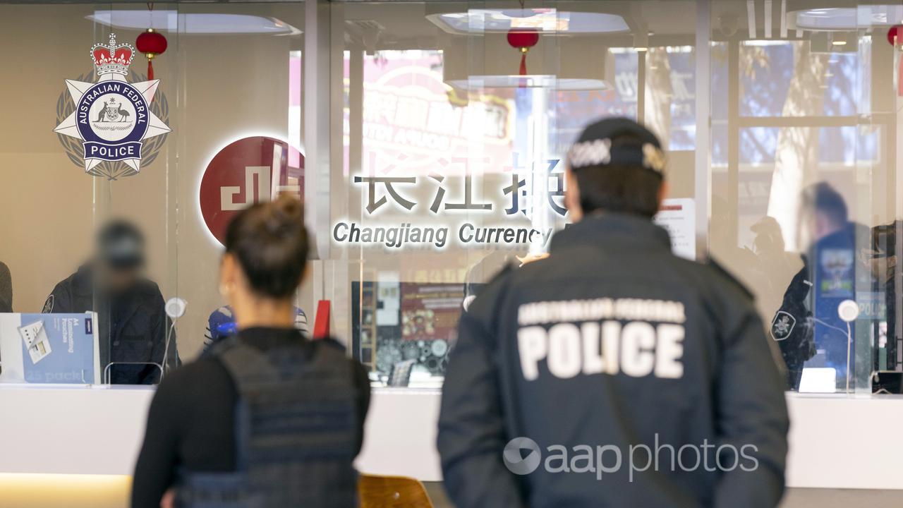 AFP officers at a shop front in Sydney