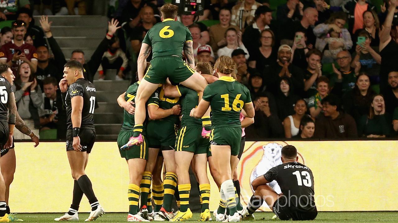 Kangaroos players celebrate a try.