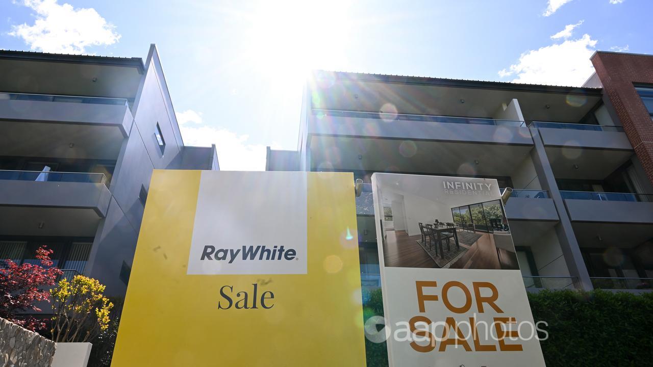 ‘For Sale’ signs are seen near apartment blocks in Canberra