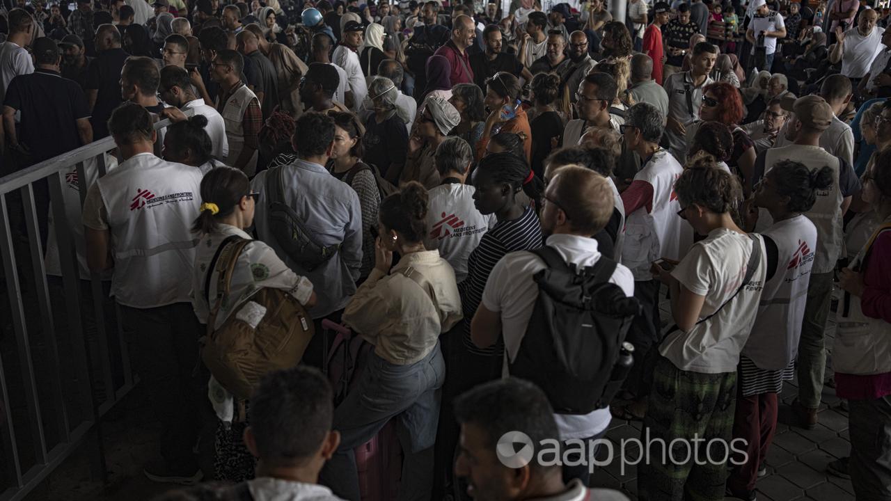 People wait to cross into Egypt at Rafah, Gaza Strip.