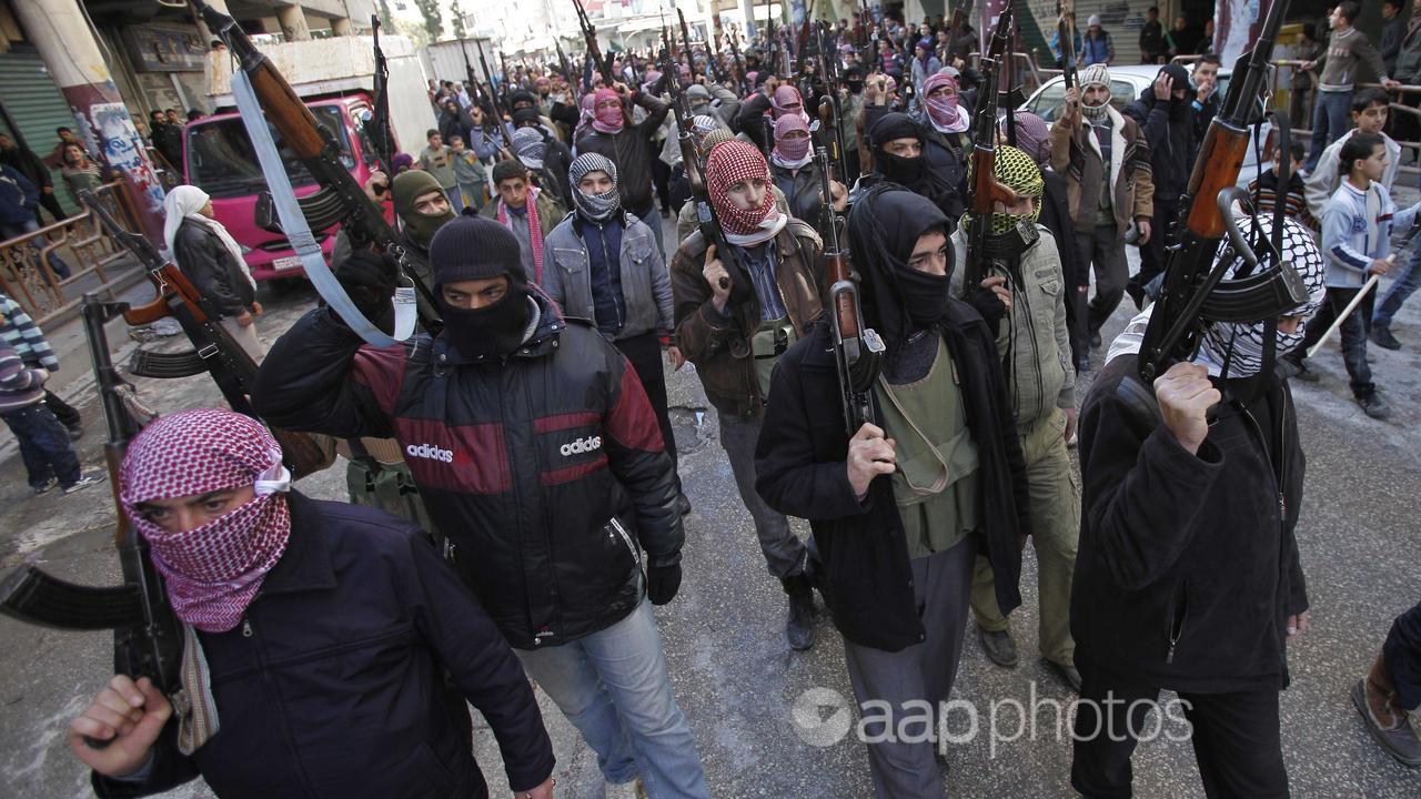 Syrian rebels march during a demonstration in Idlib.