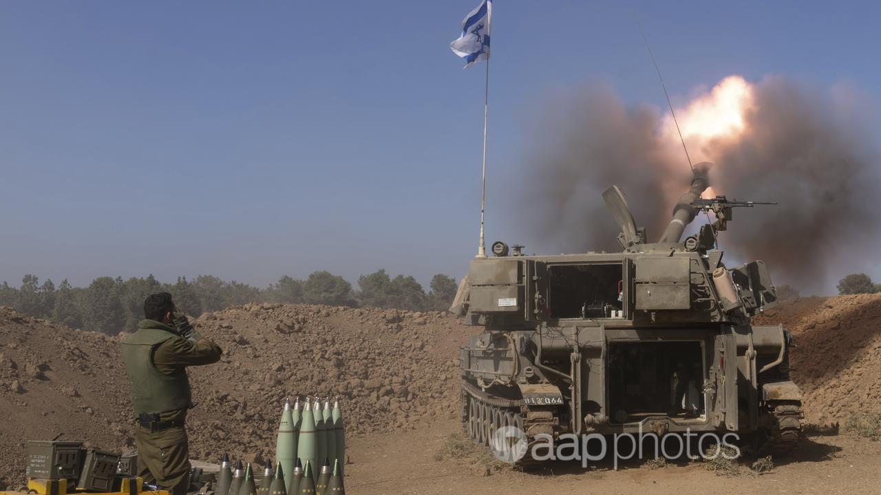 An Israeli artillery unit fires a shell from southern Israel into Gaza