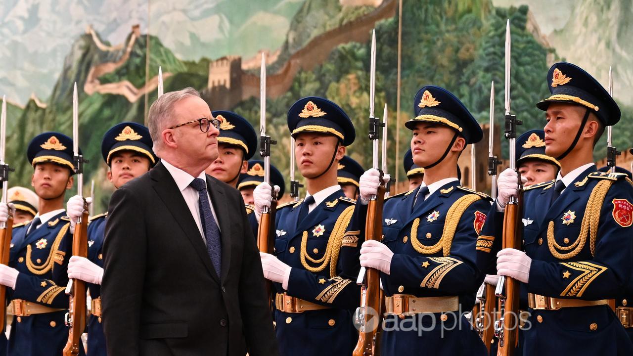 Mr Albanese inspects a guard of honour in Beijing.