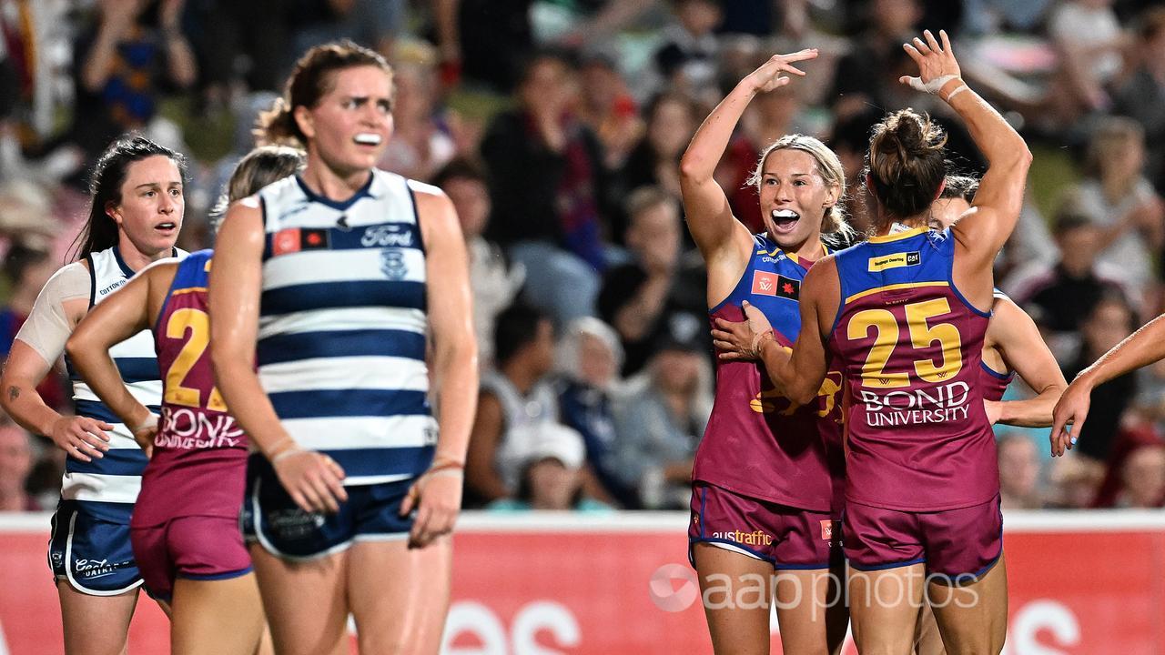 Charlotte Mullins celebrates a goal with Brisbane teammates.