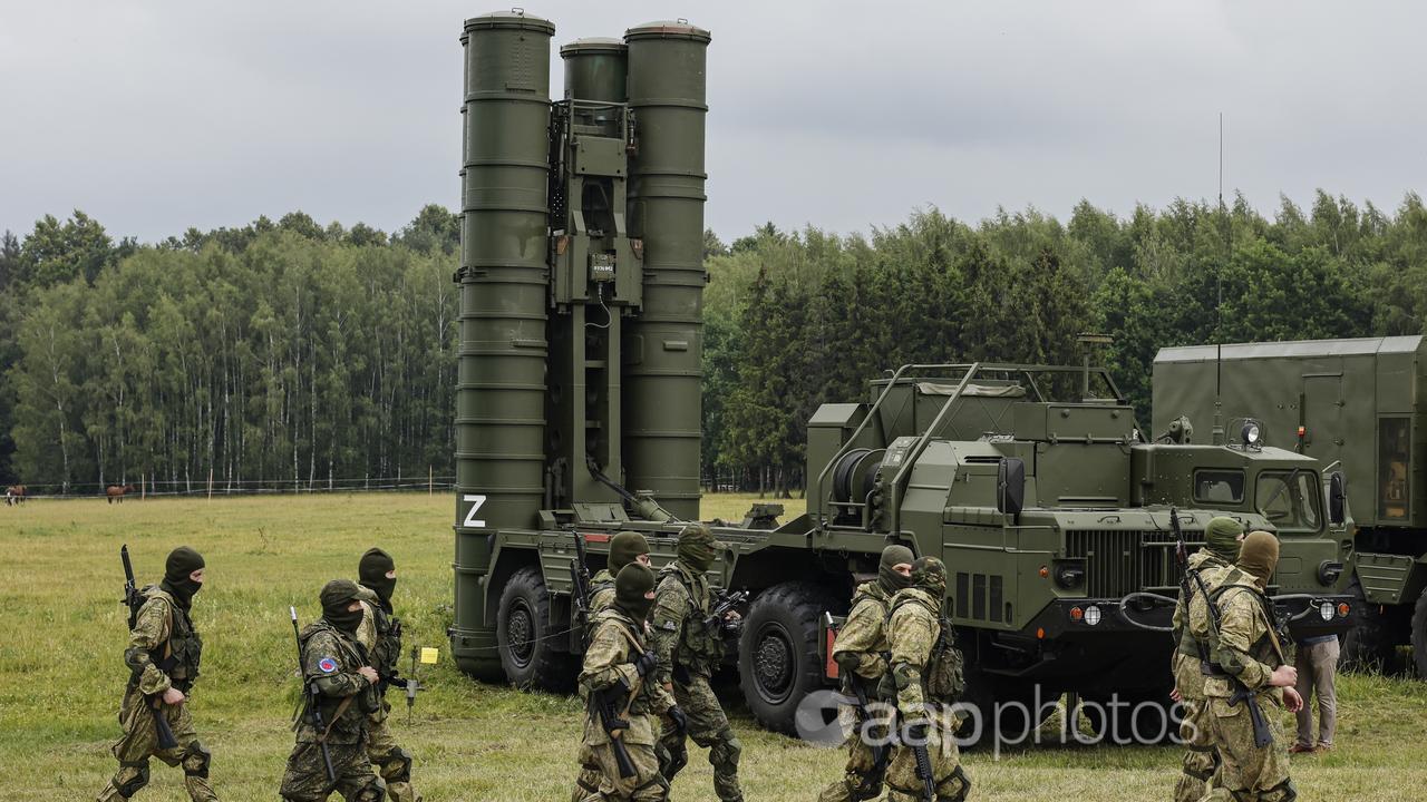 Russian soldiers walk past a Russian S-300 missile system (file image)