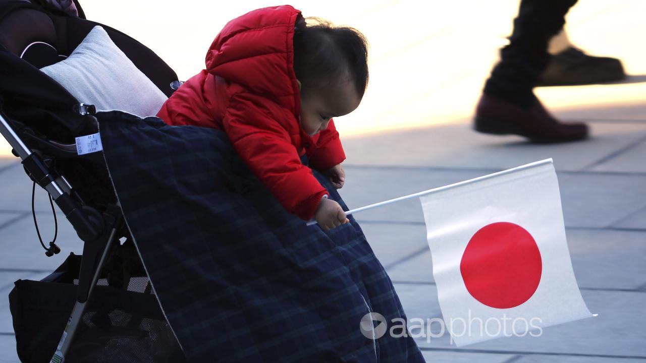 A baby waves a Japanese flag (file image)