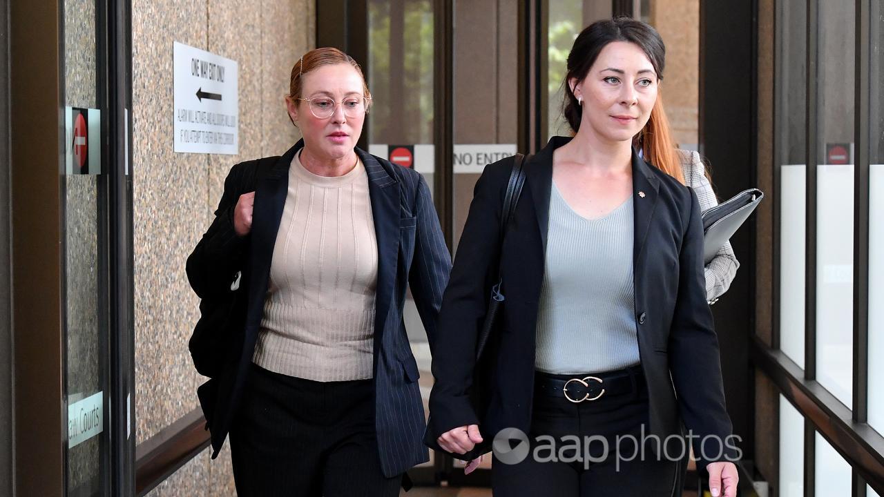 AFP agents Rebecca Cleaves (left) and Katie Thelning depart