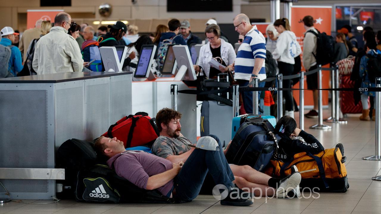 People wait for flights at Sydney Airport.