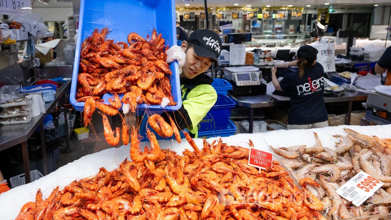 Traders serve and display seafood.