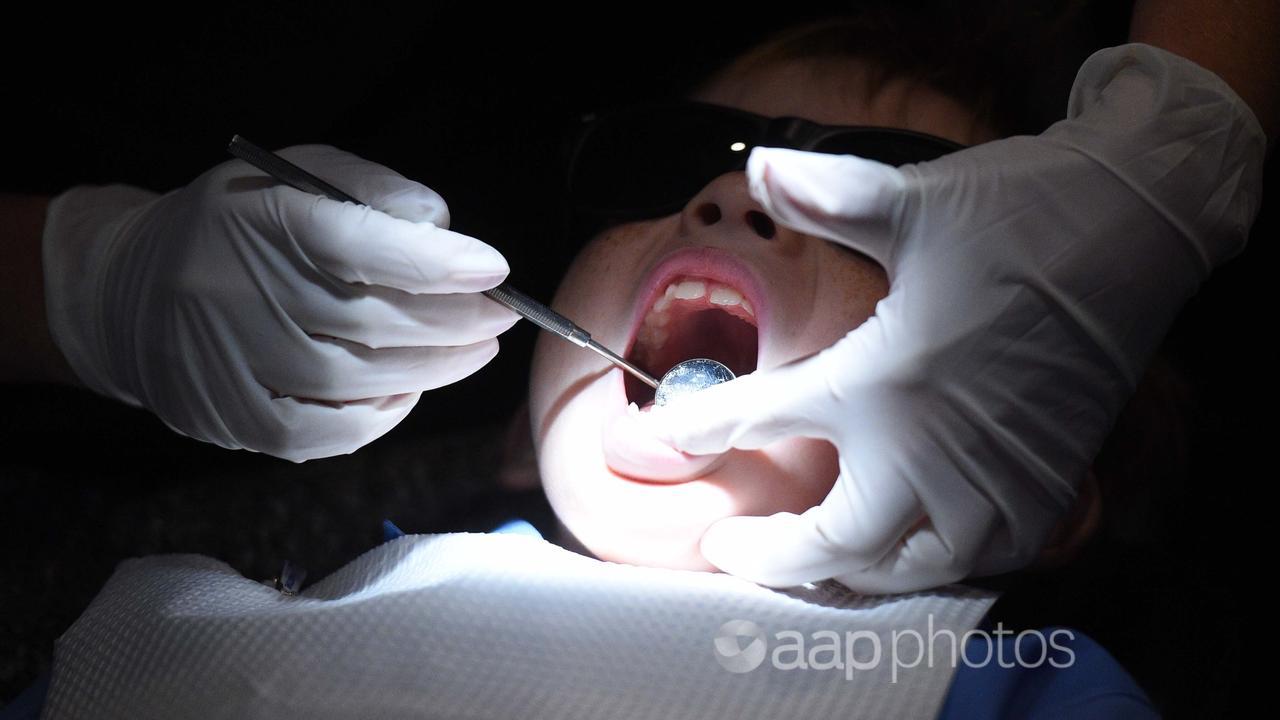 A child gets a dental examination.