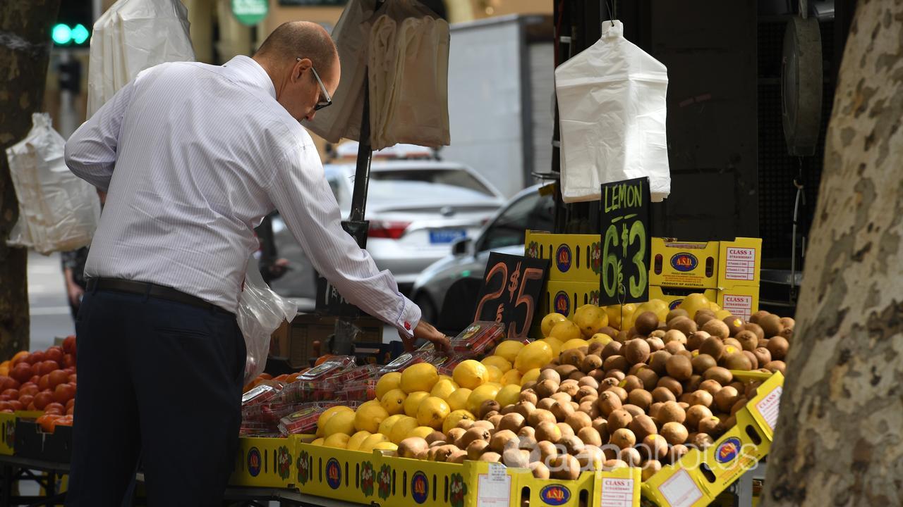 A man looks at fruit and vegetables.