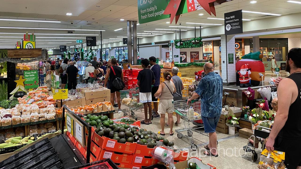 Shoppers queue at a supermarket on Christmas Eve.