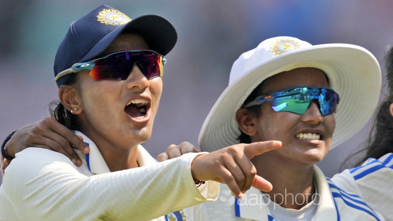 Sneh Rana (left) took 4-63 as India cleaned up Australia for 261.