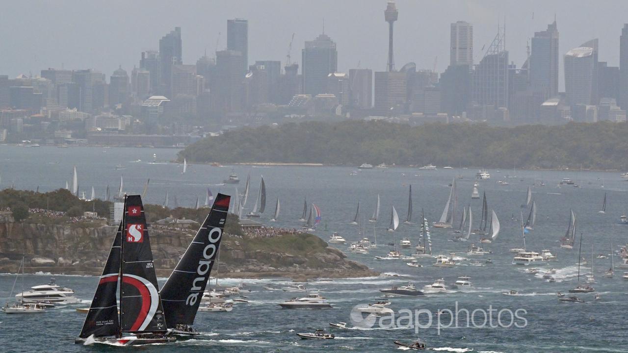 Scallywag (left) and Andoo Comanche exit Sydney Harbour on Tuesday.