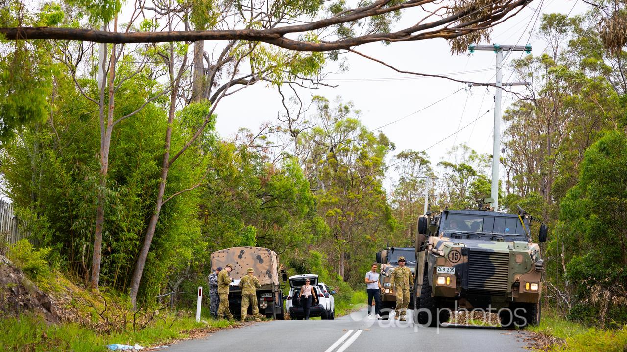 Soldiers from 11th Brigade assisting in the clean up at Coomera.