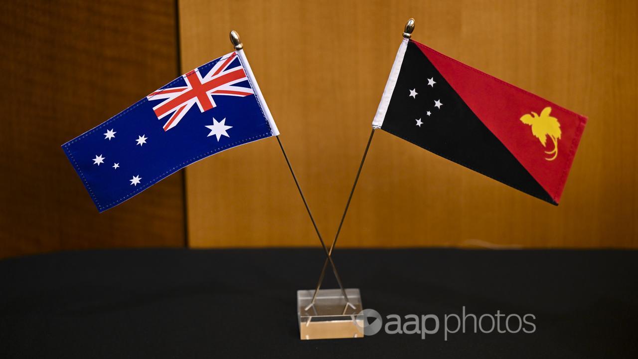 An Australian flag and the flag of Papua New Guinea