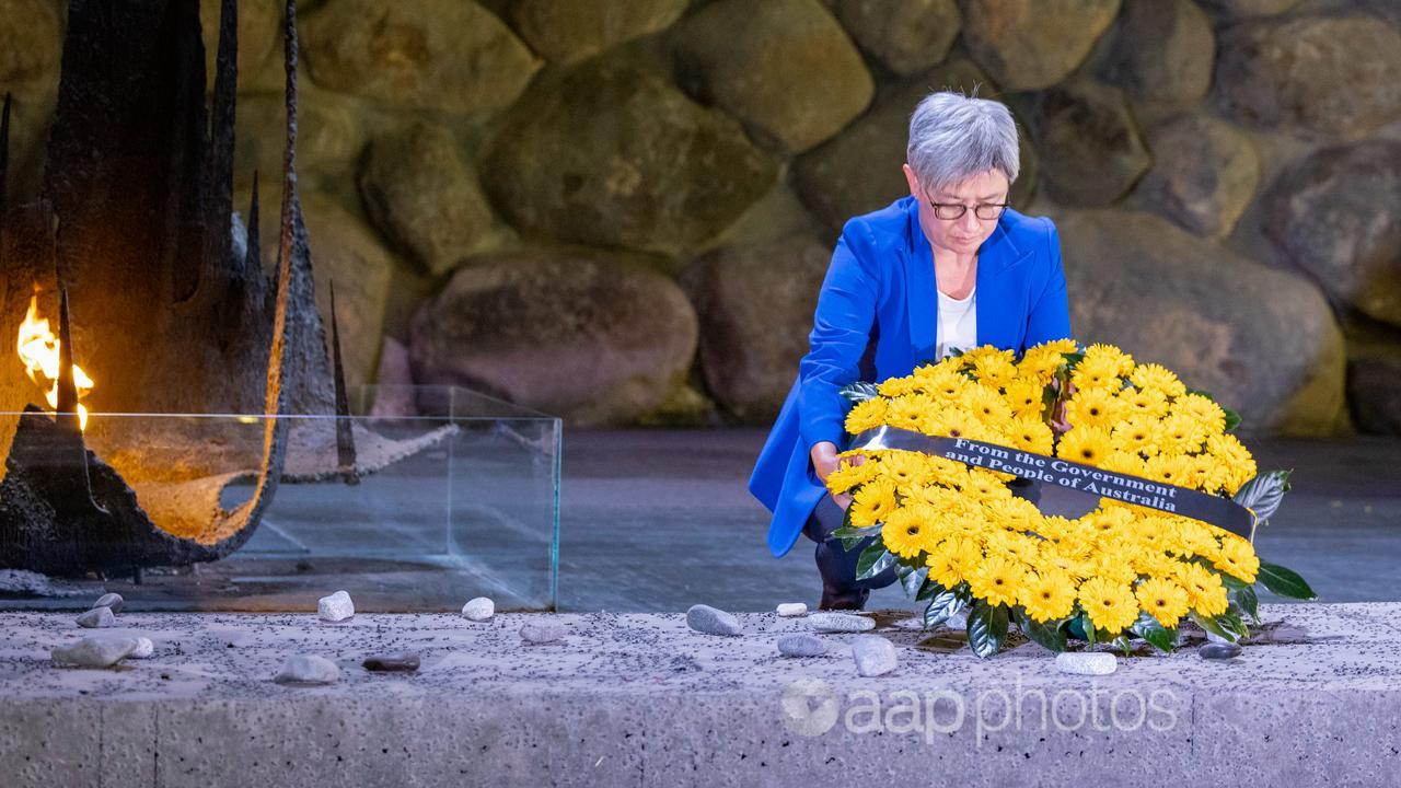 Penny Wong lays a wreath.