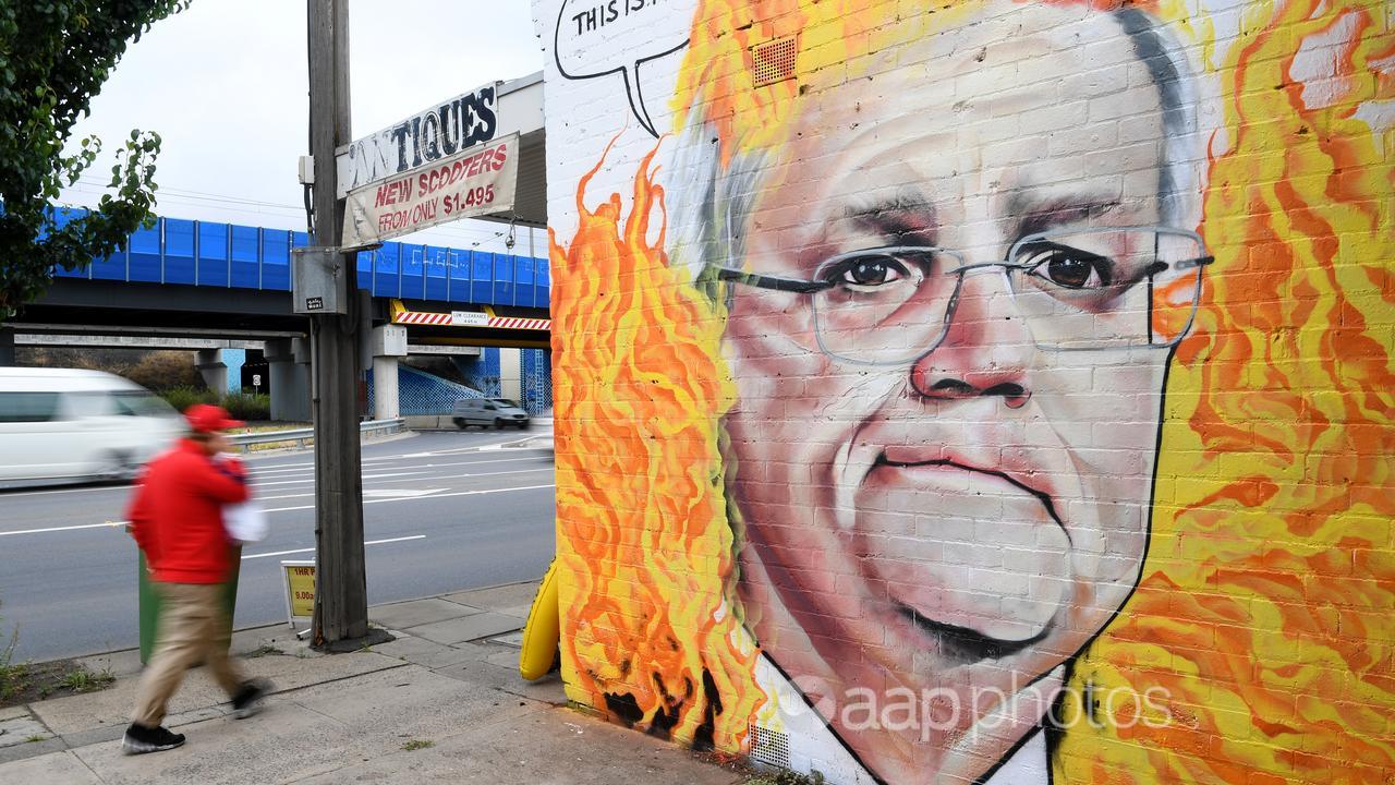 A mural of Scott Morrison among flames.