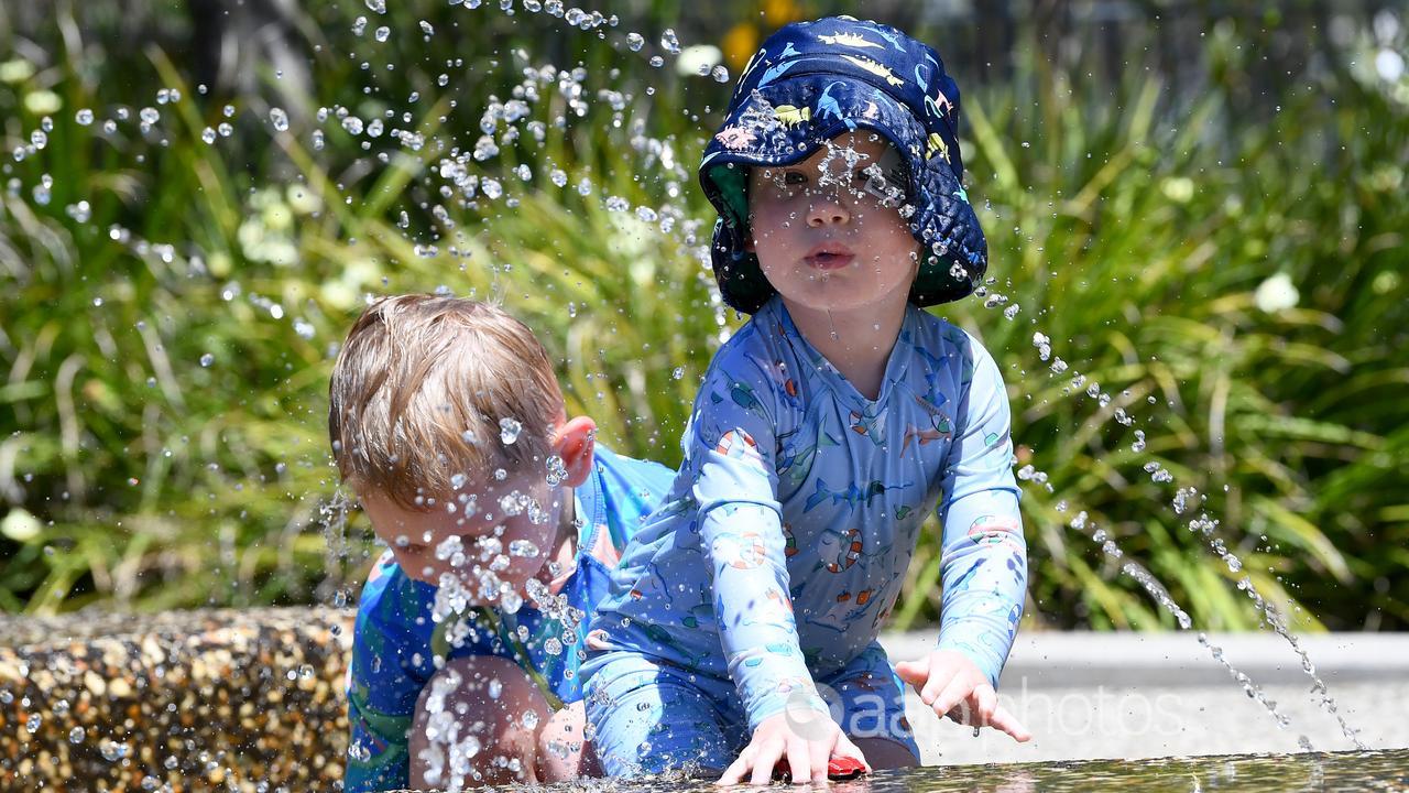 Bodhi Collins cools off at a water park in Yarrabilba west of Brisbane