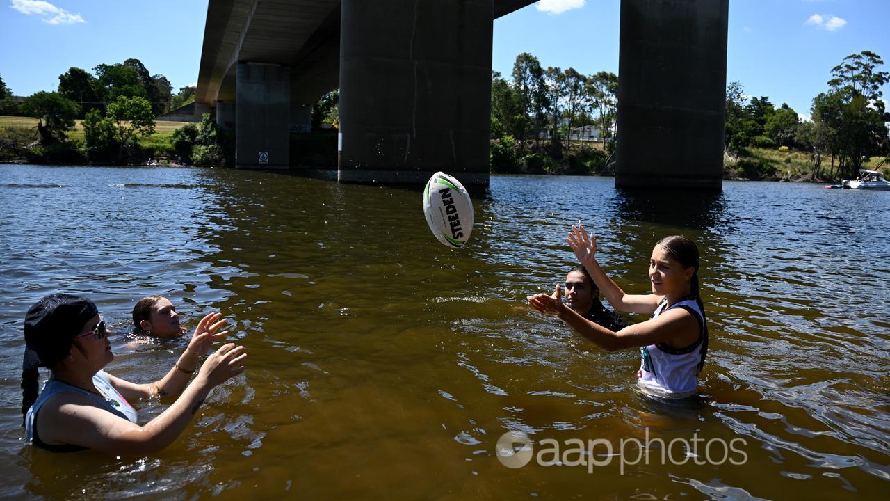 People cool off in the Nepean river at Penrith.