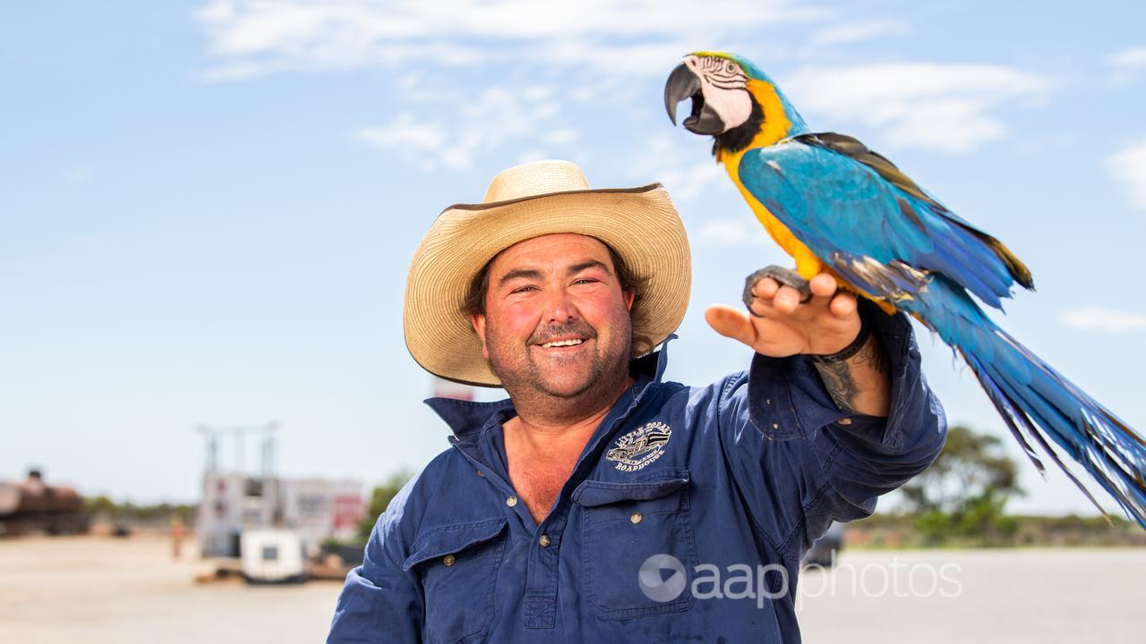 Little Topar Roadhouse co-owner Kim Starkey with macaw Charlie Girl.