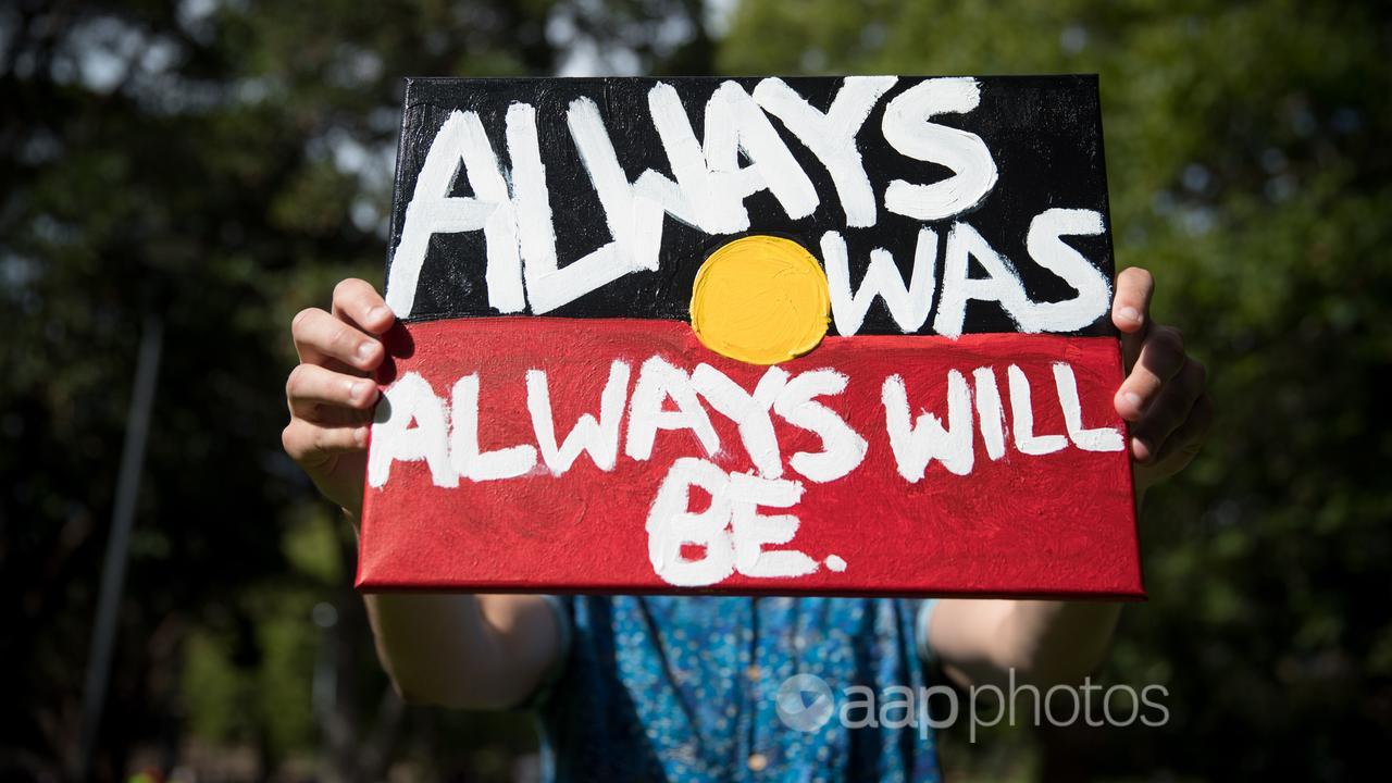 A hand-painted sign at an Invasion Day rally in Sydney.